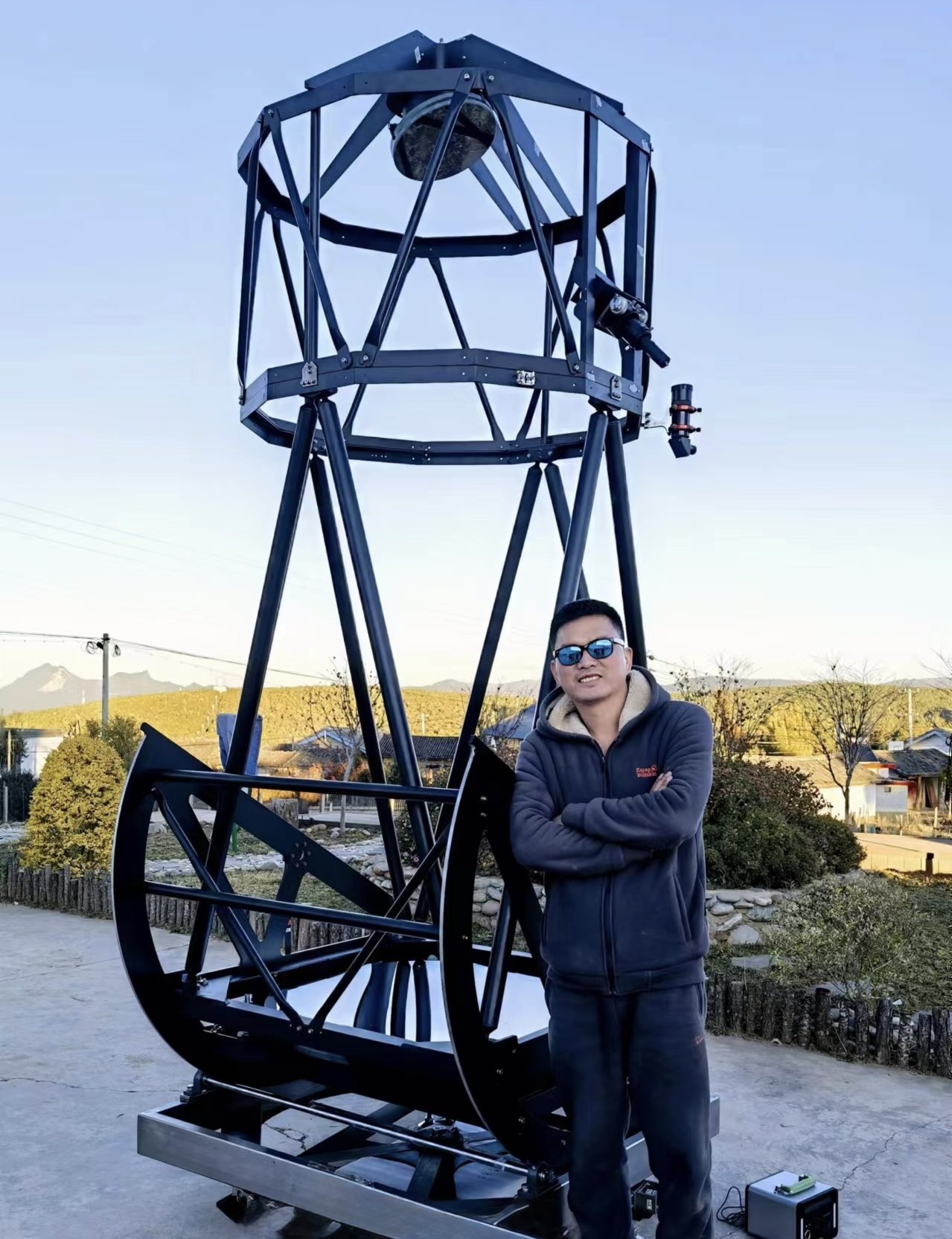 Ark, Founder and Director of the LiJiang Observatory, standing next to the UL40SO
